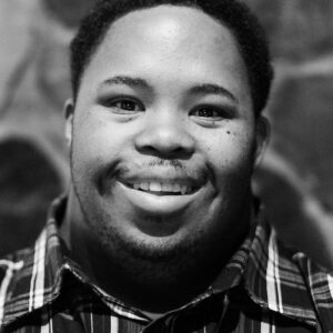 black and white portrait of boy smiling at camera